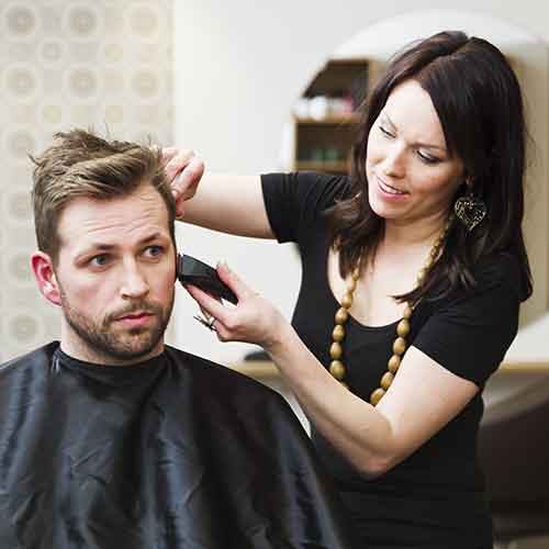 Women giving a man a haircut